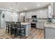 Well-lit open kitchen with an island, stainless steel appliances, and stylish pendant lighting at 1262 High Point Trl, Elizabeth, CO 80107