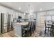 A modern kitchen with an island featuring bar seating, stainless steel appliances, and plenty of counter space at 1262 High Point Trl, Elizabeth, CO 80107
