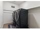 Modern laundry room with front load washer and dryer and laundry matt at 1262 High Point Trl, Elizabeth, CO 80107