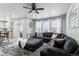 Bright and airy living room featuring an oversized sectional, hardwood floors, and an adjacent kitchen area at 1262 High Point Trl, Elizabeth, CO 80107