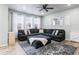 Inviting living room with a large sectional sofa, stylish rug, and plenty of natural light from the large windows at 1262 High Point Trl, Elizabeth, CO 80107
