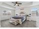 The main bedroom offers a tray ceiling, a plush bed, and large windows for ample natural light at 1262 High Point Trl, Elizabeth, CO 80107