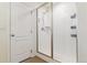 The shower features a glass door and white tile surround at 1262 High Point Trl, Elizabeth, CO 80107