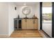 Stylish bar area with sleek cabinetry, a wine fridge, a decorative mirror, and access to an outdoor patio at 4301 Osceola St, Denver, CO 80212
