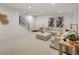 Finished basement featuring plush carpeting, recessed lighting, a sectional sofa, and a modern staircase at 4301 Osceola St, Denver, CO 80212