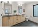 Bathroom featuring dual sinks, square mirrors, and granite countertops at 4301 Osceola St, Denver, CO 80212