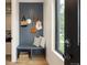 Stylish entryway features a built-in bench, hooks, and contemporary design at 4301 Osceola St, Denver, CO 80212