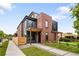 Contemporary home featuring a brick exterior, wood fence, and inviting walkway at 4301 Osceola St, Denver, CO 80212