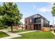 Modern two-story home featuring brick and black siding, manicured lawn, and a well-maintained sidewalk at 4301 Osceola St, Denver, CO 80212