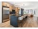 Spacious kitchen featuring an island with seating and stainless steel appliances at 4301 Osceola St, Denver, CO 80212