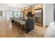 Modern kitchen features a long island, wood cabinetry, and lots of space at 4301 Osceola St, Denver, CO 80212