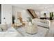 Open-concept living room with stairs, neutral tones, hardwood flooring, and lots of natural light at 4301 Osceola St, Denver, CO 80212