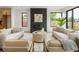 Bright living room features a modern fireplace, plush seating, and windows that let in natural light at 4301 Osceola St, Denver, CO 80212