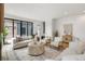 Bright living room features modern furnishings, a neutral palette, and sliding doors to outdoor space at 4301 Osceola St, Denver, CO 80212