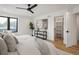 Bright main bedroom featuring a ceiling fan, modern decor, and a walk-in closet at 4301 Osceola St, Denver, CO 80212