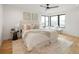 Serene main bedroom features natural light, a plush bed, and hardwood floors at 4301 Osceola St, Denver, CO 80212