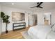 Bright main bedroom featuring a ceiling fan, hardwood floors, and modern decor at 4301 Osceola St, Denver, CO 80212