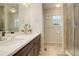 Modern bathroom featuring a double sink vanity and glass-enclosed shower at 16102 E 47Th Pl, Denver, CO 80239
