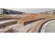Scenic community park view with hardscape details, lush landscaping, and townhomes at 16102 E 47Th Pl, Denver, CO 80239