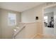Bright landing area featuring a window with blinds and access to the upstairs rooms at 16102 E 47Th Pl, Denver, CO 80239