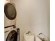 A laundry room featuring a stacked washer and dryer, plus laundry baskets at 16102 E 47Th Pl, Denver, CO 80239