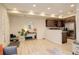 Bright living room with modern decor, open to kitchen, showcasing a functional and stylish living space at 16102 E 47Th Pl, Denver, CO 80239