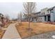 A street view of homes with sidewalks and maintained lawns on a cold winter day at 16102 E 47Th Pl, Denver, CO 80239