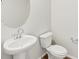 The bathroom features a modern pedestal sink, round mirror, and a standard toilet at 6532 N Malaya St, Aurora, CO 80019