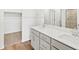 Beautiful bathroom with double sink, long vanity, and walk-in closet and shower in view at 6532 N Malaya St, Aurora, CO 80019