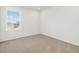 A bedroom with a window and neutral carpet at 6532 N Malaya St, Aurora, CO 80019