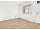 Bright bedroom features wood floors, a large window, and a door at 6532 N Malaya St, Aurora, CO 80019