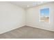Neutral bedroom featuring modern carpet and a window at 6532 N Malaya St, Aurora, CO 80019