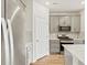 Bright kitchen features stainless steel appliances, white cabinets, and a large island with a sink at 6532 N Malaya St, Aurora, CO 80019