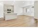 Modern open kitchen and living area bathed in natural light featuring wood floors at 6532 N Malaya St, Aurora, CO 80019