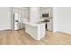 Bright kitchen features stainless steel appliances, white cabinets, and a large island with a sink at 6532 N Malaya St, Aurora, CO 80019
