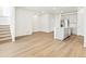 Spacious living room leading into the modern kitchen with island and new appliances at 6532 N Malaya St, Aurora, CO 80019