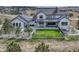 Aerial view of a modern home with a well-manicured yard and outdoor seating area at 2690 Fox View Trl, Franktown, CO 80116