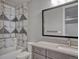 Stylish bathroom featuring patterned tile shower and vanity with ample counter space at 2690 Fox View Trl, Franktown, CO 80116