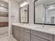 Bathroom with dual sinks, quartz countertops, modern fixtures, and tiled floor at 2690 Fox View Trl, Franktown, CO 80116