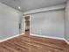 Cozy bedroom featuring hardwood floors and a glass door leading to the living area at 2690 Fox View Trl, Franktown, CO 80116