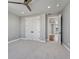 Bright bedroom featuring plush carpet, a modern ceiling fan, and double door closet at 2690 Fox View Trl, Franktown, CO 80116