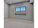 Bedroom with a large window offering natural light and neutral-toned walls and carpet at 2690 Fox View Trl, Franktown, CO 80116