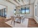 Bright dining area with wood beams features large windows and a sliding door at 2690 Fox View Trl, Franktown, CO 80116