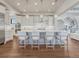 Bright kitchen features stainless steel appliances, modern light fixtures, and a large center island at 2690 Fox View Trl, Franktown, CO 80116