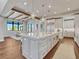 Bright kitchen with a central island, stainless steel appliances, pendant lights, and hardwood floors at 2690 Fox View Trl, Franktown, CO 80116