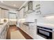 Modern kitchen featuring stainless steel appliances, white cabinets, and a stylish backsplash at 2690 Fox View Trl, Franktown, CO 80116