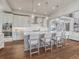 Bright kitchen features stainless steel appliances, modern light fixtures, and a large center island at 2690 Fox View Trl, Franktown, CO 80116