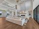Bright living room boasts hardwood floors, a fireplace, and a soaring ceiling with a modern light fixture at 2690 Fox View Trl, Franktown, CO 80116