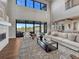 Bright open living room with large windows, fireplace, and stylish decor at 2690 Fox View Trl, Franktown, CO 80116
