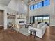 Bright living room with a fireplace, expansive windows, and modern furnishings, creating an inviting atmosphere at 2690 Fox View Trl, Franktown, CO 80116